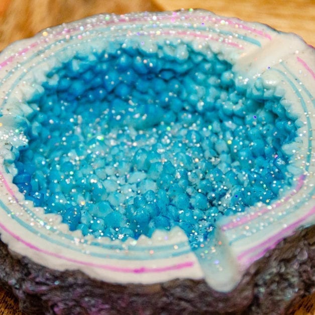Close-up of sparkling blue geode ashtray interior.