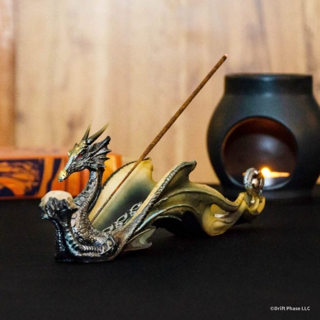 Dragon holding a skull incense burner.