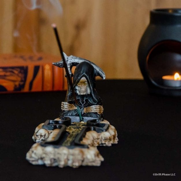 Wide photo of the Grim Reaper Catacombs stick incense burner with burning incense.