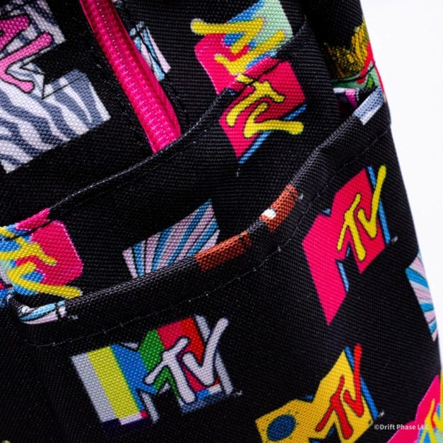 Close-up photo of the slip pockets on the side of the Loungefly MTV Logo full sized nylon backpack.