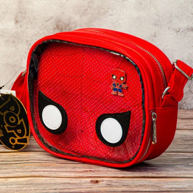Wide photo of Spider-Man POP! crossbody purse by Loungefly on a table top.