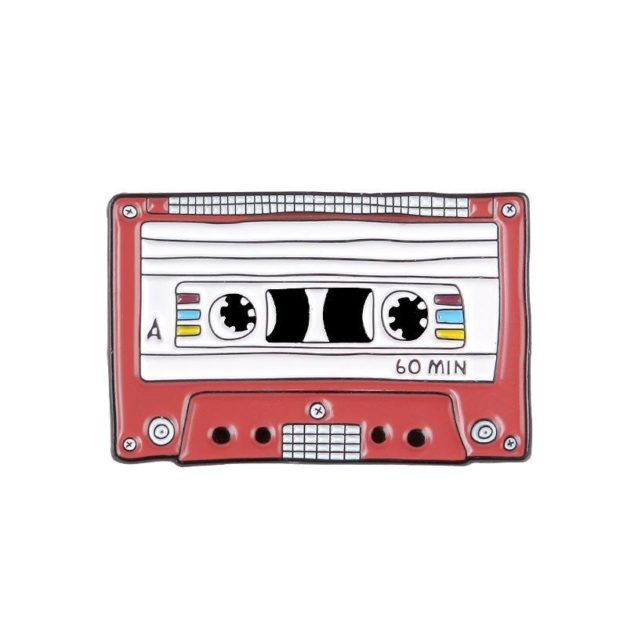 Enamel Pin shaped like a cassette tape with red trim.